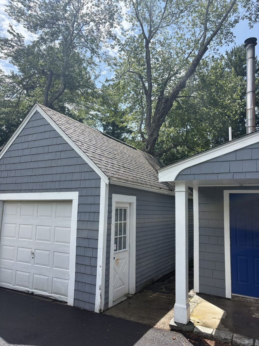 Same garage with its roof cleared of moss and algae after cleaning